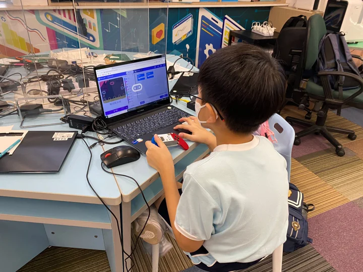 A student learning to program at a laptop
