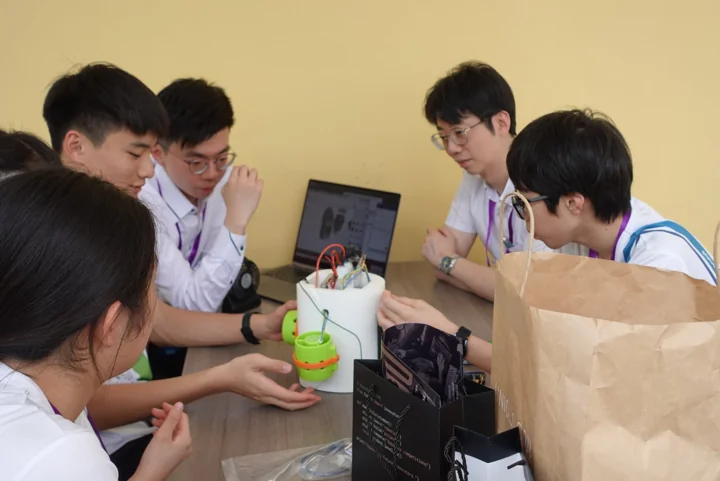 A school team discussing its robot design